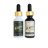 Two dropper bottles of Acrely Farms extracts on a solid white background. The left bottle is a white glass bottle with a gold collar and a dark green label for White CBG Extract. The right bottle is a black glass bottle with a gold collar and a cream label for Hemp Extract.