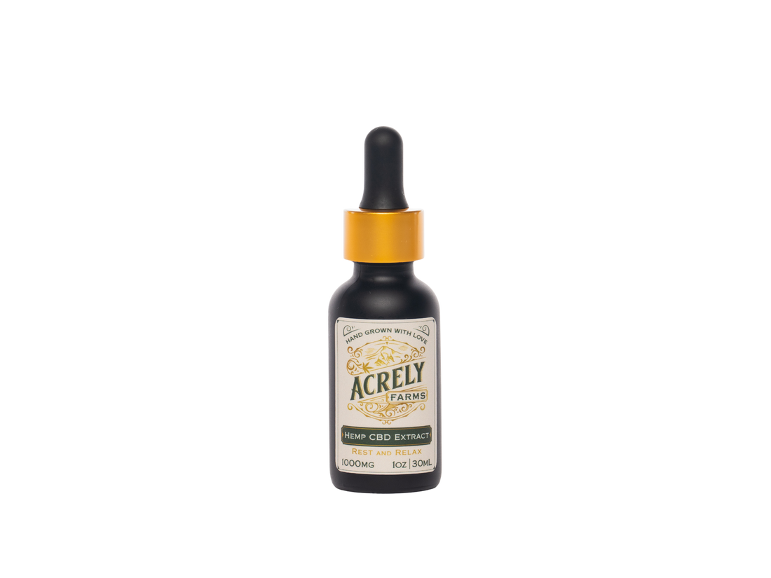 A small amber glass dropper bottle of Acrely Farms Hemp CBD Extract with a black rubber dropper top and a shiny gold collar, centered on a plain white background.