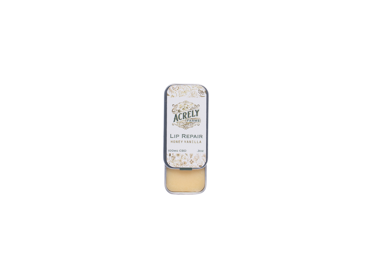 A small rectangular metal tin of Acrely Naturals Lip Repair balm in Honey Vanilla, shown open with the beige balm visible inside, centered on a plain white background.