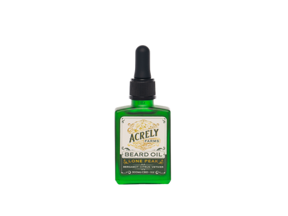 A green glass bottle of Acrely Farms Lone Peak Beard Oil with a black dropper cap and a cream-colored label, centered on a plain white background.