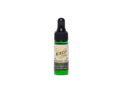 A small green glass dropper bottle of Acrely Farms Beard Oil featuring a black dropper cap and a cream-colored label with gold text, set against a plain white background.