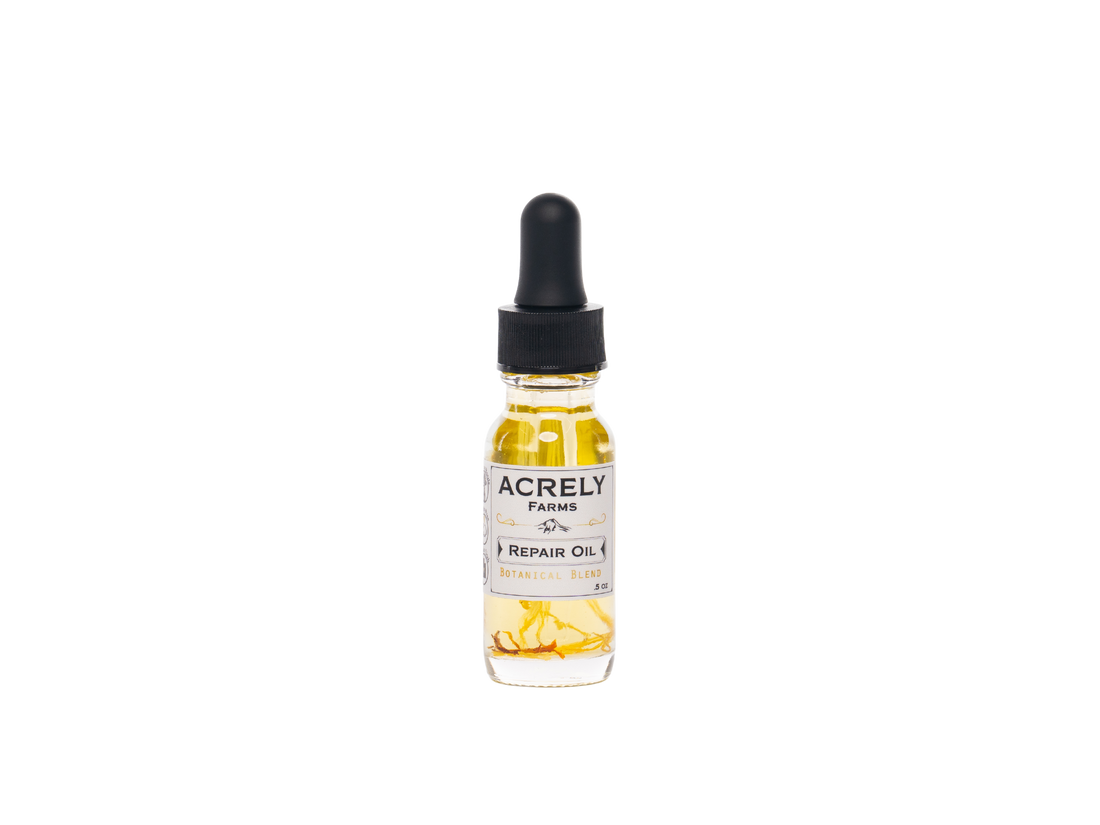A small glass dropper bottle of Acrely Farms Repair Oil with botanical blend, containing golden yellow oil, set against a plain white background.