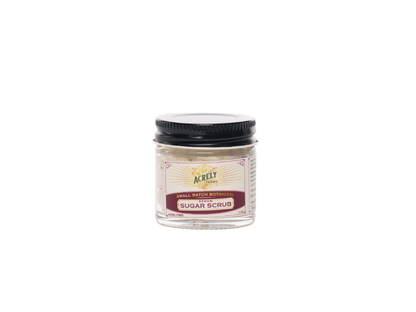 A small jar of Acrely Farms Sugar Scrub with a black lid and cream-colored label, centered on a plain white background.