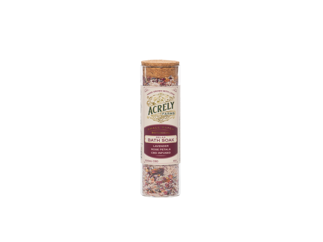 Acrely Farms Lavender &amp; Rose Eucalyptus Bath Soak in a clear cylindrical jar with a cork lid and cream label, shown on a plain white background.