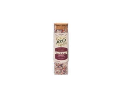 Acrely Farms Lavender &amp; Rose Eucalyptus Bath Soak in a clear cylindrical jar with a cork lid and cream label, shown on a plain white background.
