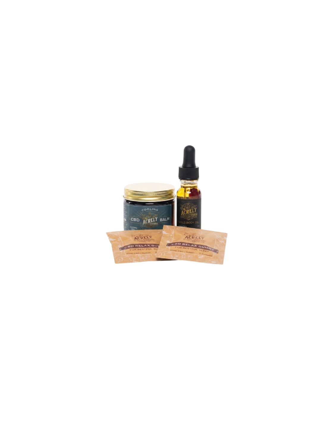 A small product set on a white background featuring a dark blue jar with a gold lid, a dark amber dropper bottle with a black top, and two small tan packets in front.