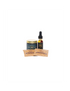 A small product set on a white background featuring a dark blue jar with a gold lid, a dark amber dropper bottle with a black top, and two small tan packets in front.